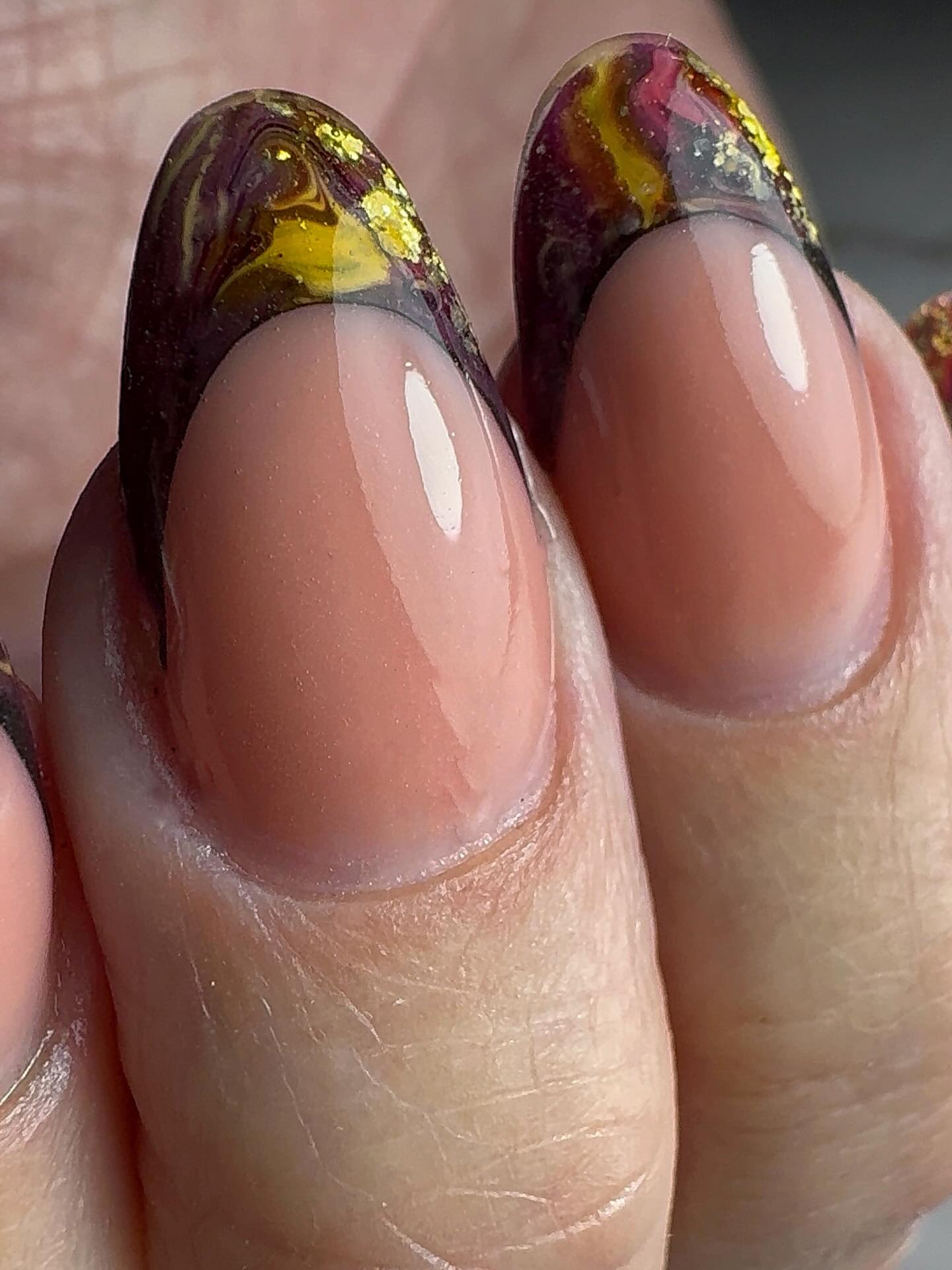 Gemarmerde bordeaux en gouden French tips, close-up